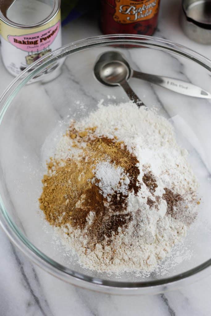 Dry ingredients for the donut batter in a glass bowl.