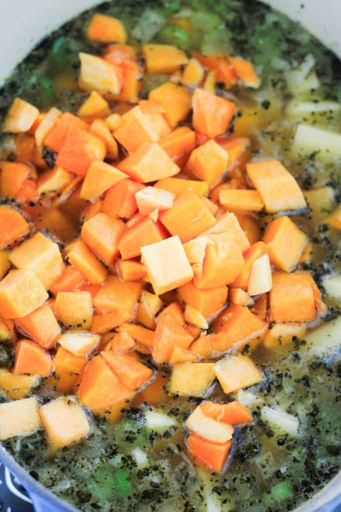 Potatoes and butternut squash added to the pot of soup.