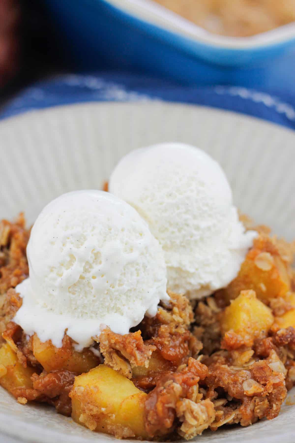 Very close-up shot of Pumpkin apple crisp with two scoops of ice cream on top.