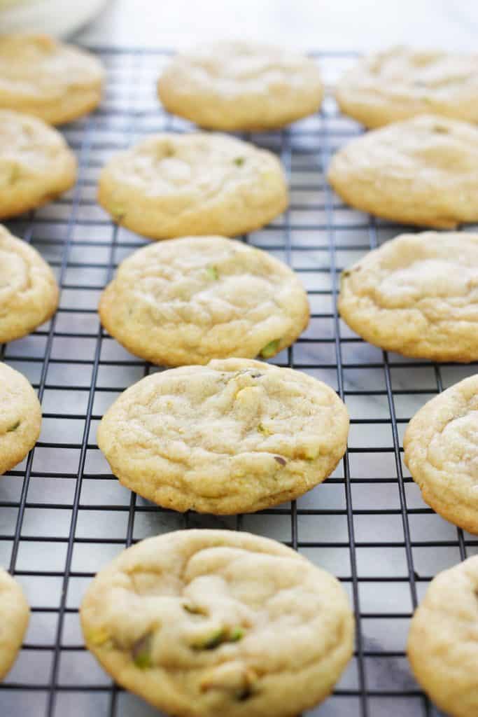 Baked pistachio nut cookies on a cooling rack.