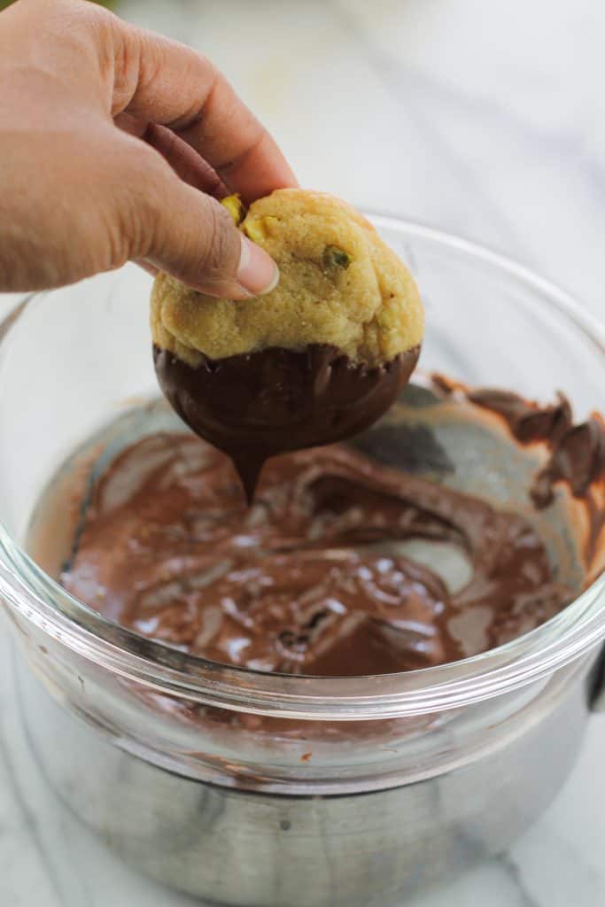 Pistachio nut cookie dipped in chocolate.