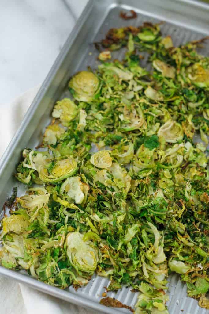 Roasted shaved brussels sprouts on baking pan.