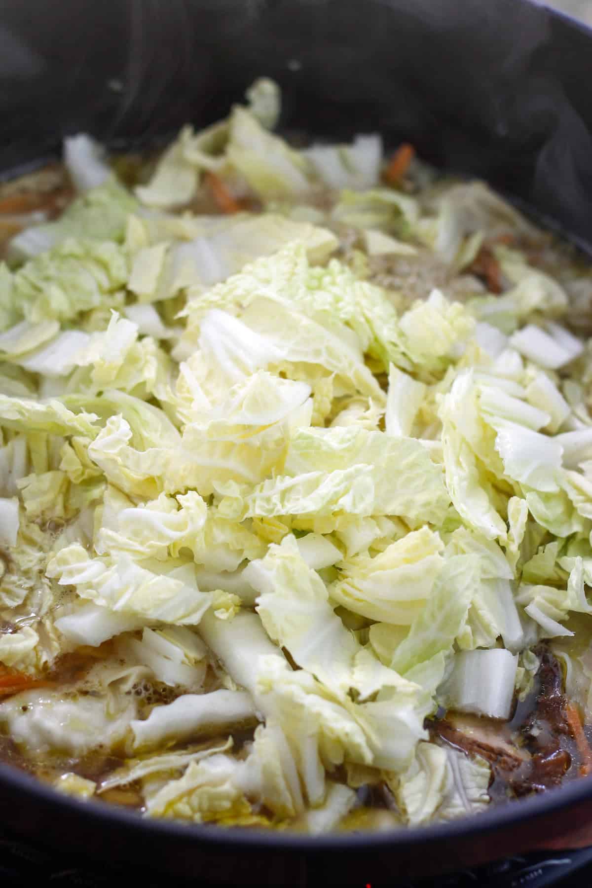 Chopped napa cabbage added to dutch oven with the vegetables and potstickers.