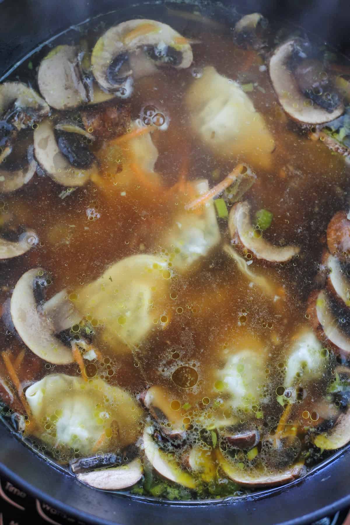 Potstickers added to dutch oven with the vegetables.