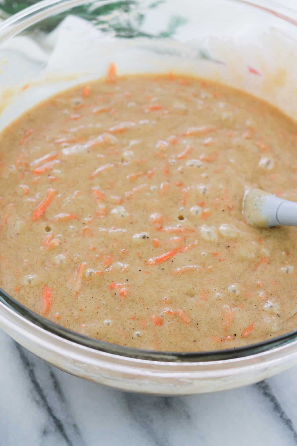 Carrot cake ingredients in a glass bowl.