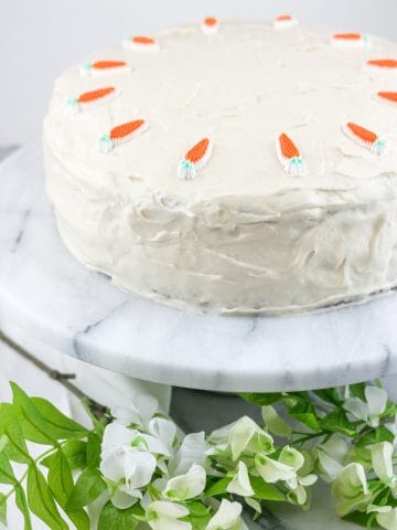 ced carrot cake with carrot decorations.