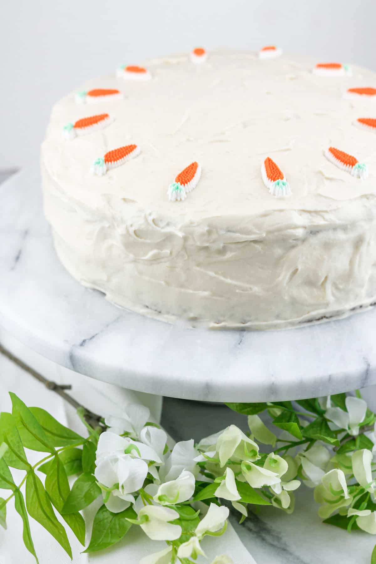 ced carrot cake with carrot decorations.