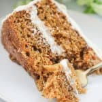 Super moist sliced two layer carrot cake on a plate.