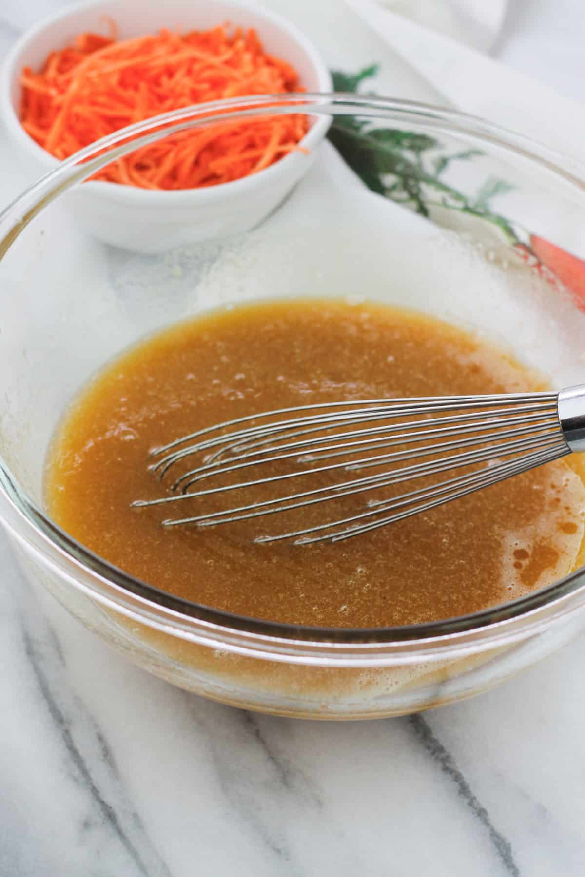 Wet ingredients for the carrot cake in a glass bowl.