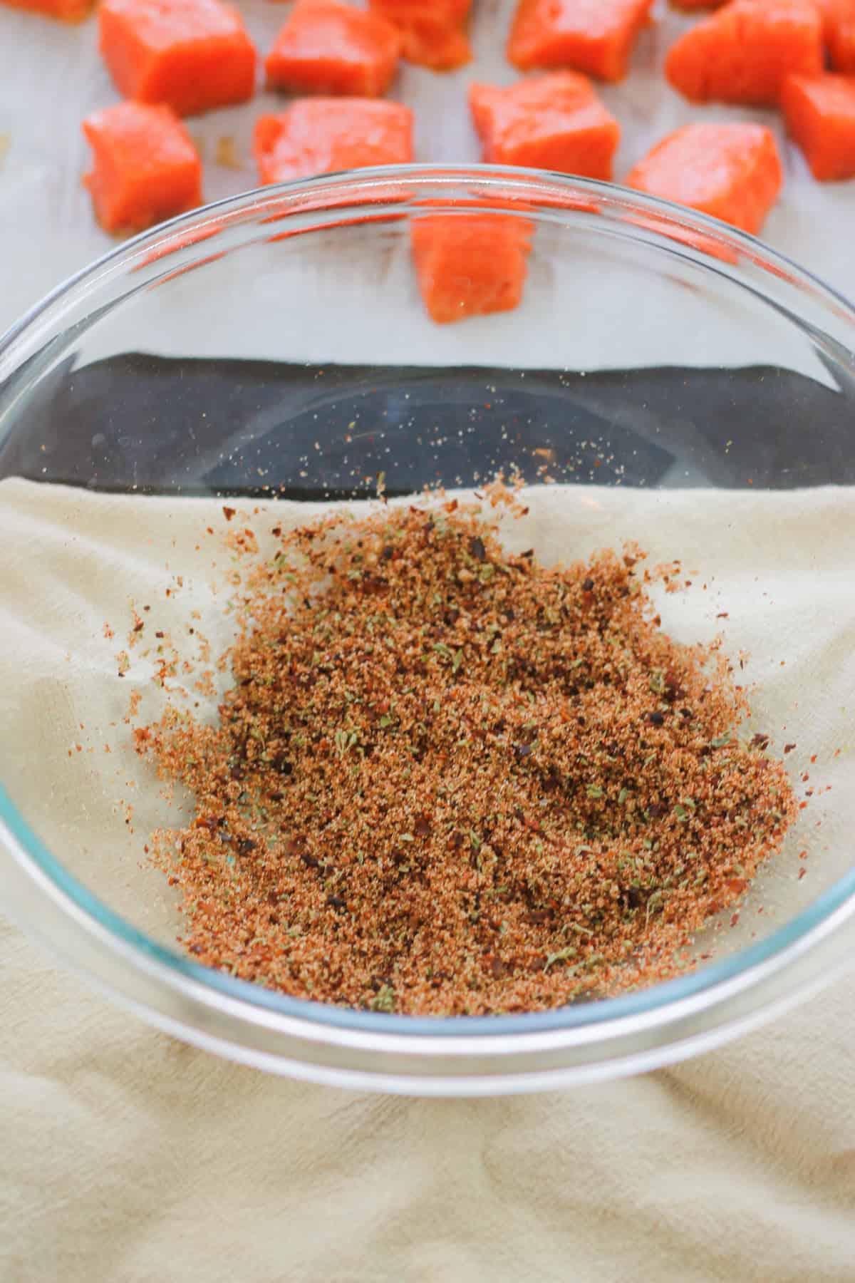 Spice and herb mix for spicy air fryer salmon bites in a glass bowl.