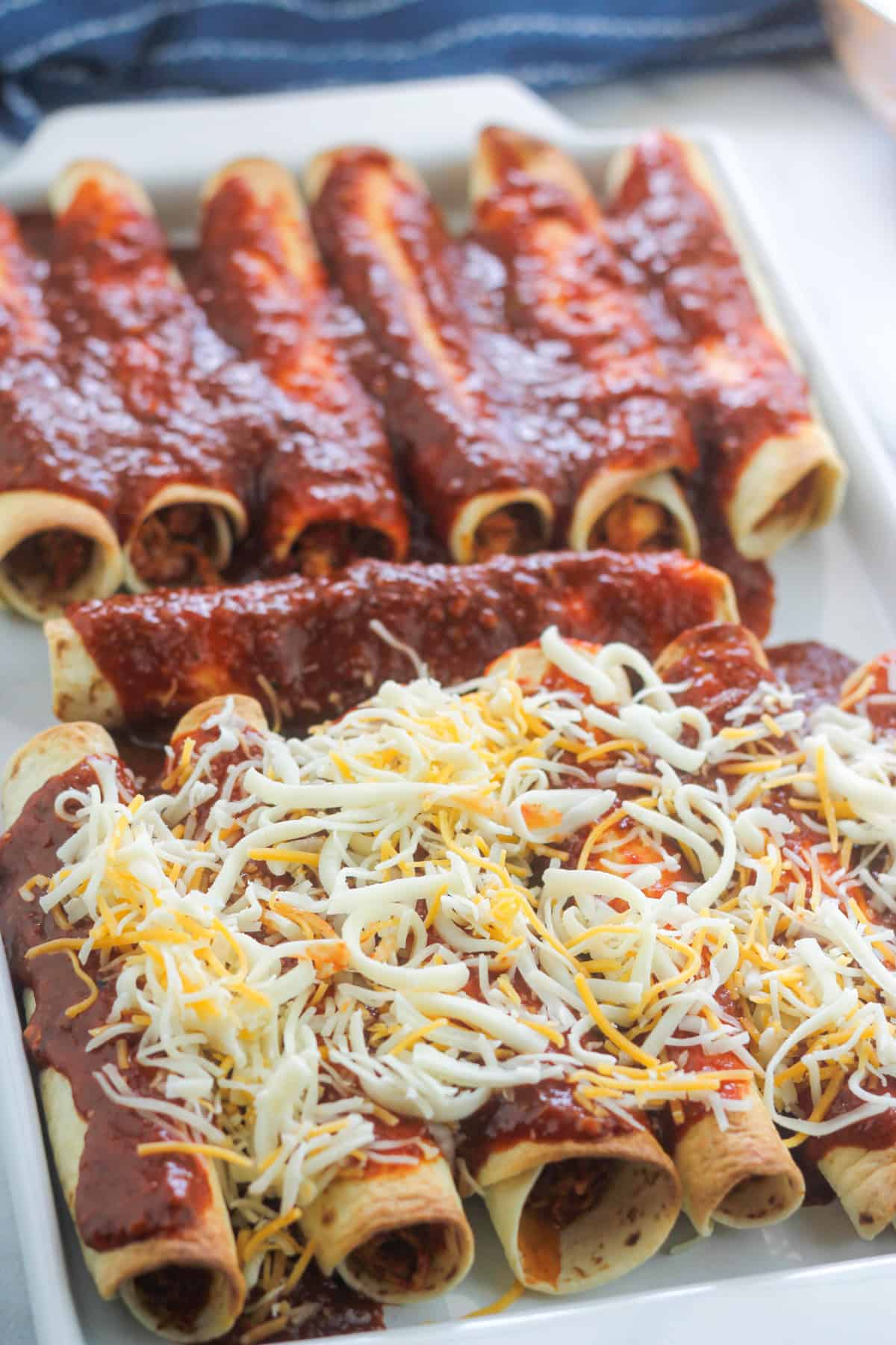 Baked chipotle chicken taquitos layered with chipotle sauce and cheese.