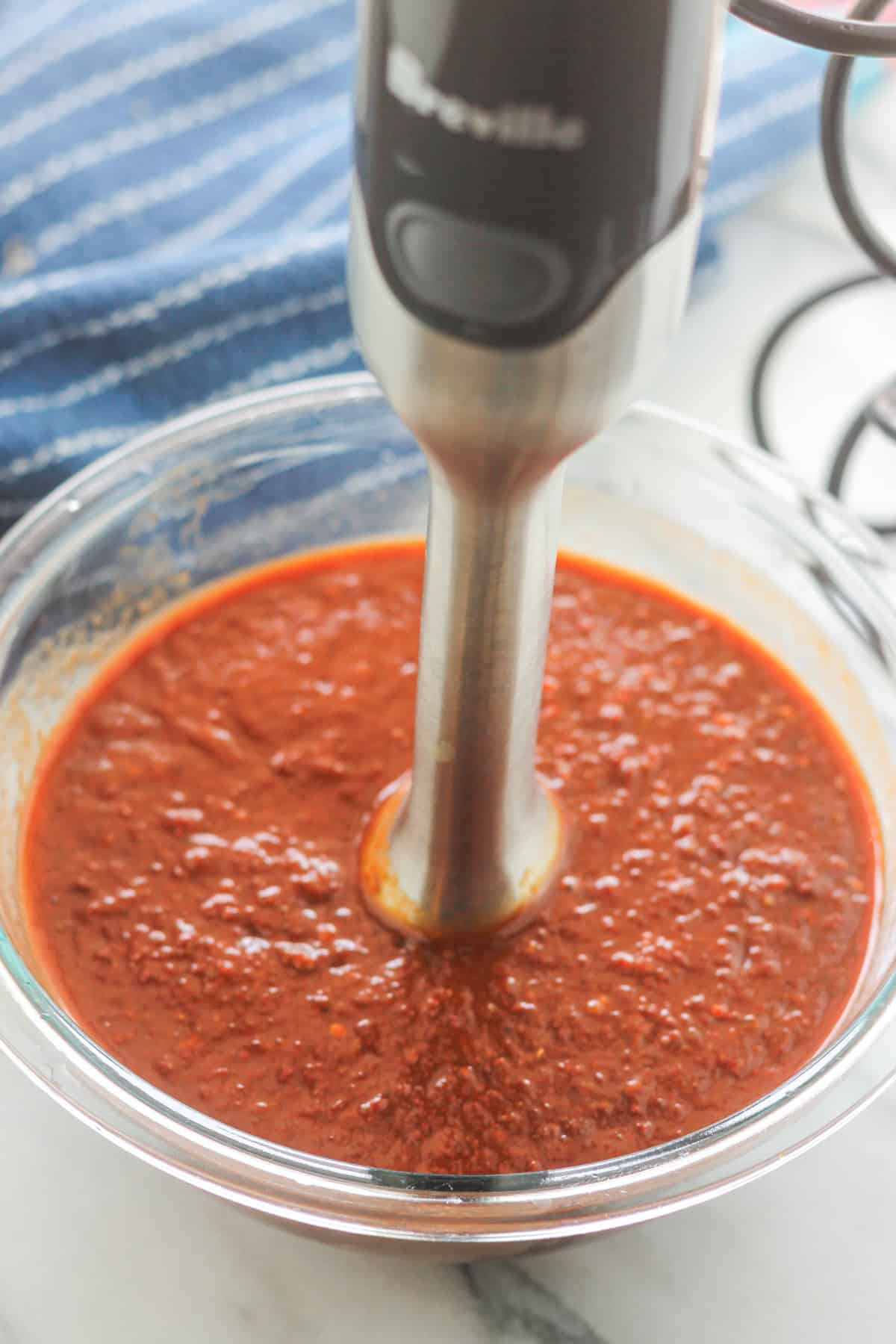 Bowl of chipotle jalapeno mixture blended using an immersion blender.
