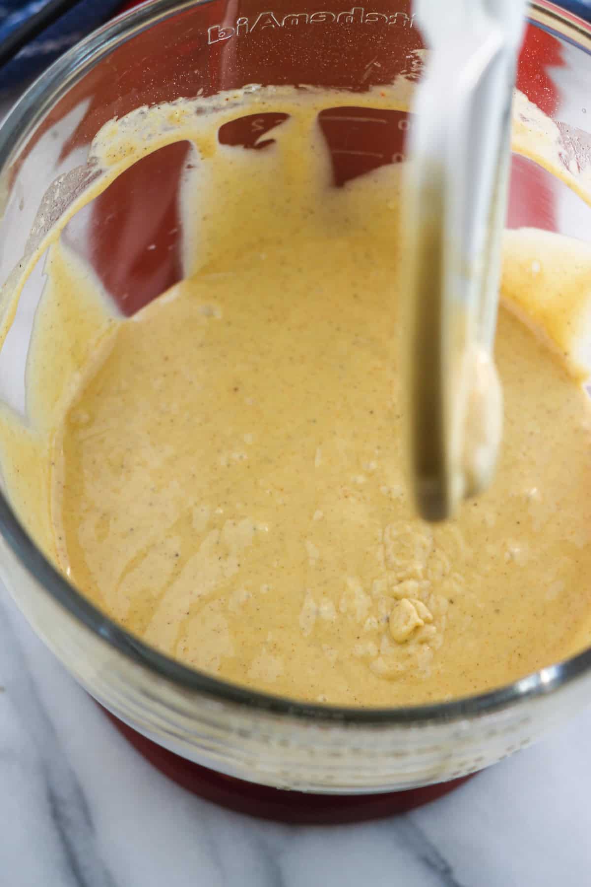 Boxed cake mix blended with spice, oil, eggs, and vanilla in a stand mixing bowl.