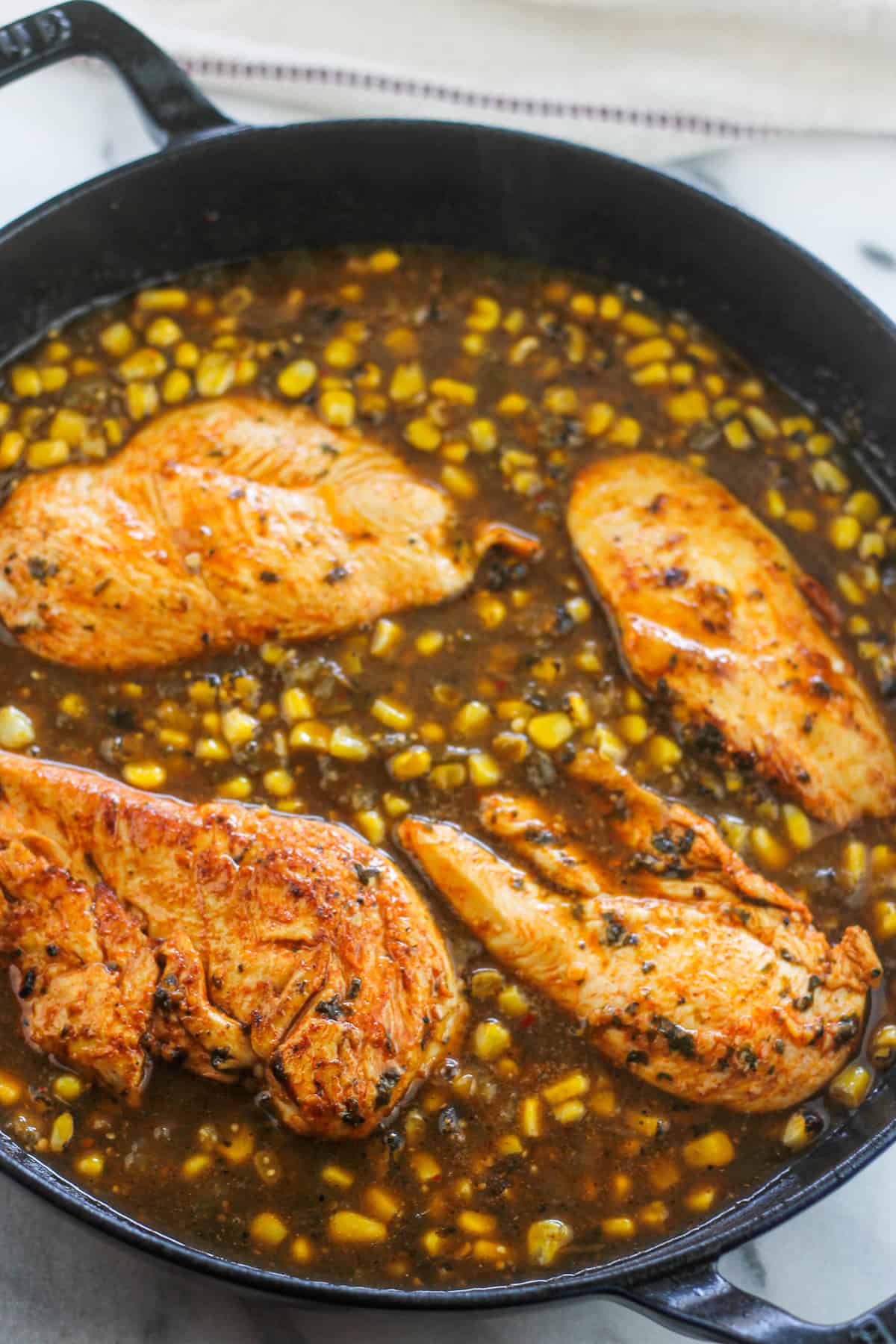 Chicken breast added back to pan with the fire roasted corn and salsa verde.