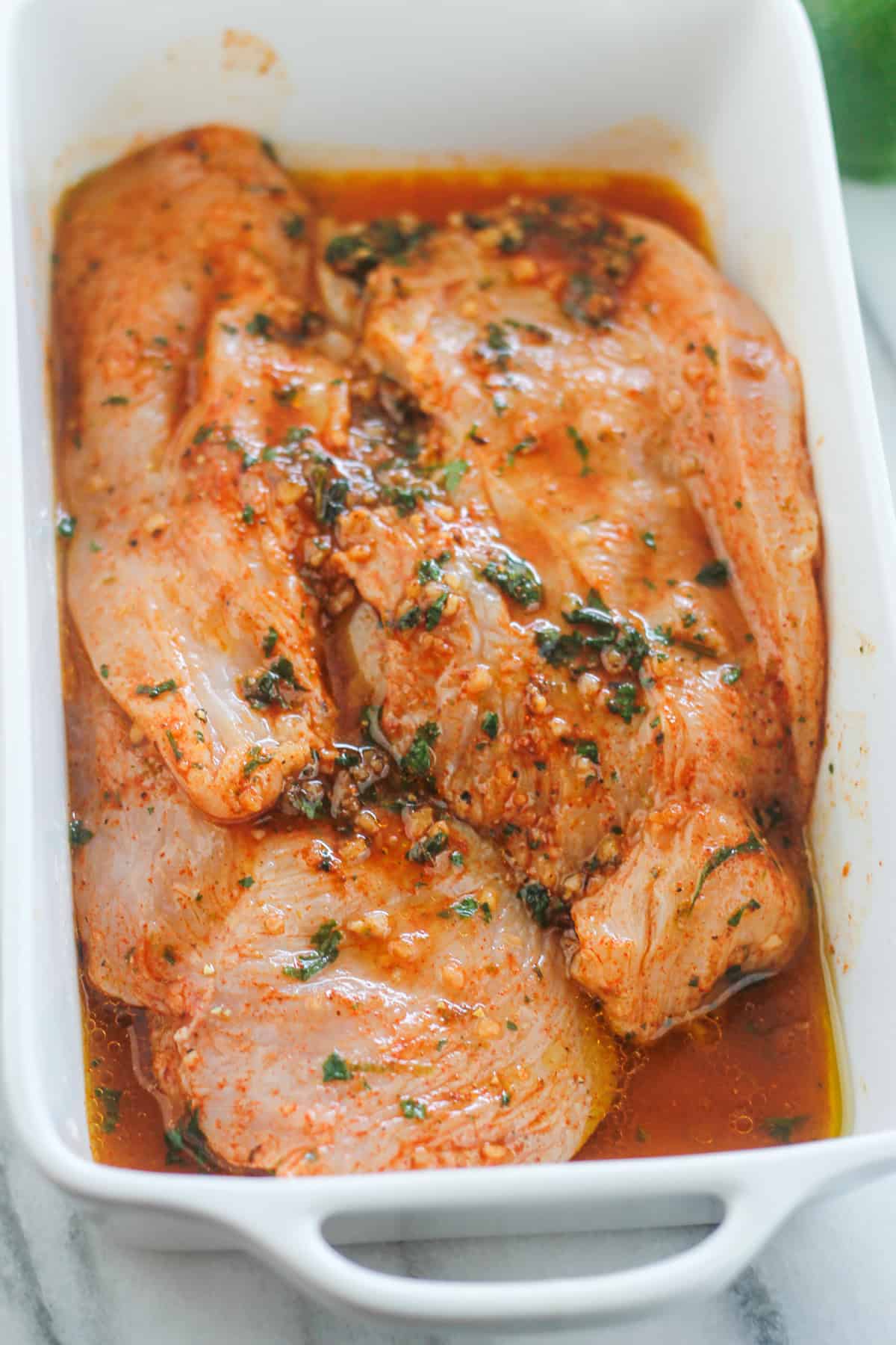 Chicken breast marinating in cilantro lime sauce.