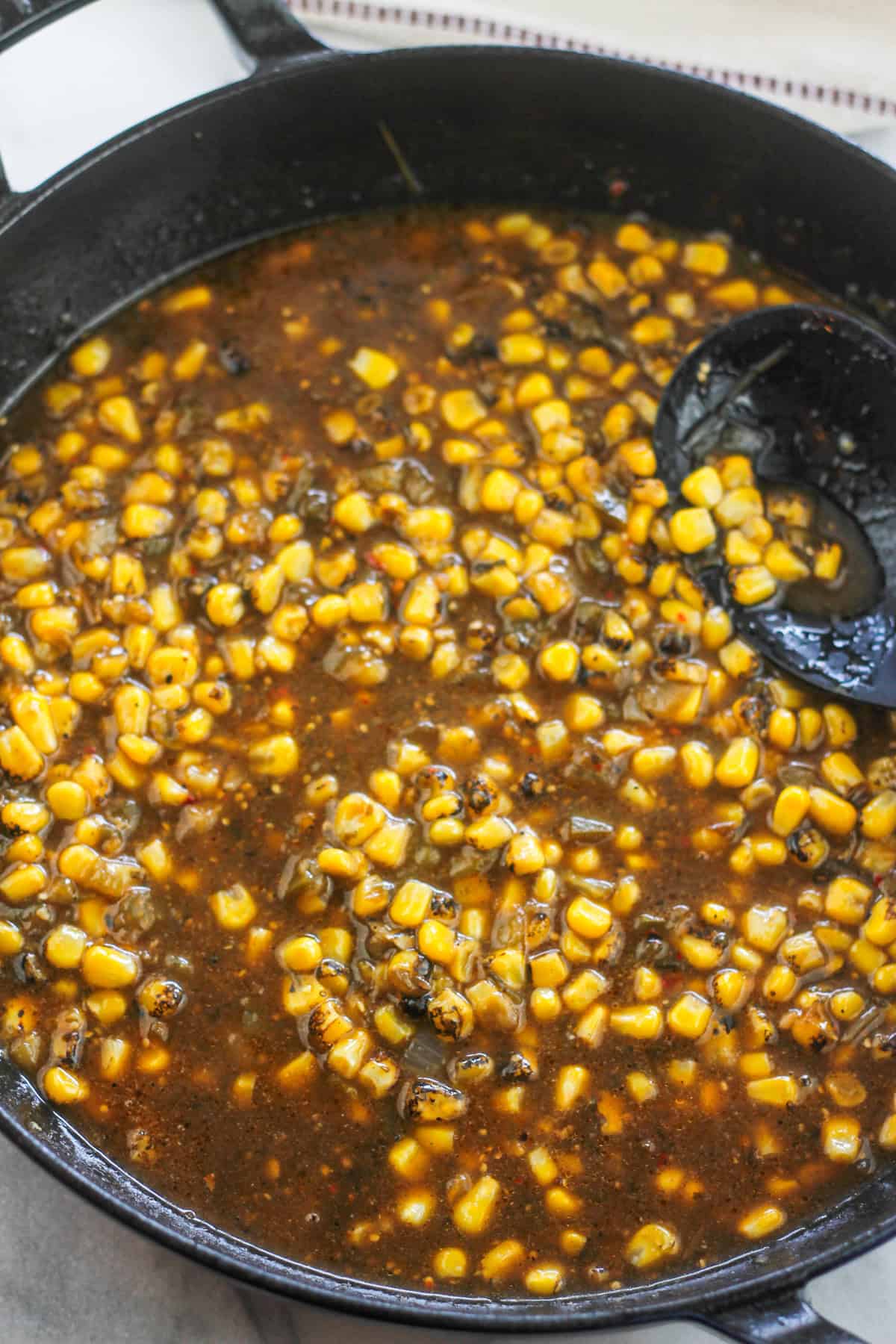 Fire roasted corn and salsa verde added to the pan with chicken breast.