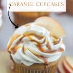 Apple cider cupcakes with cream cheese frosting garnished with caramel sauce and apple slice.