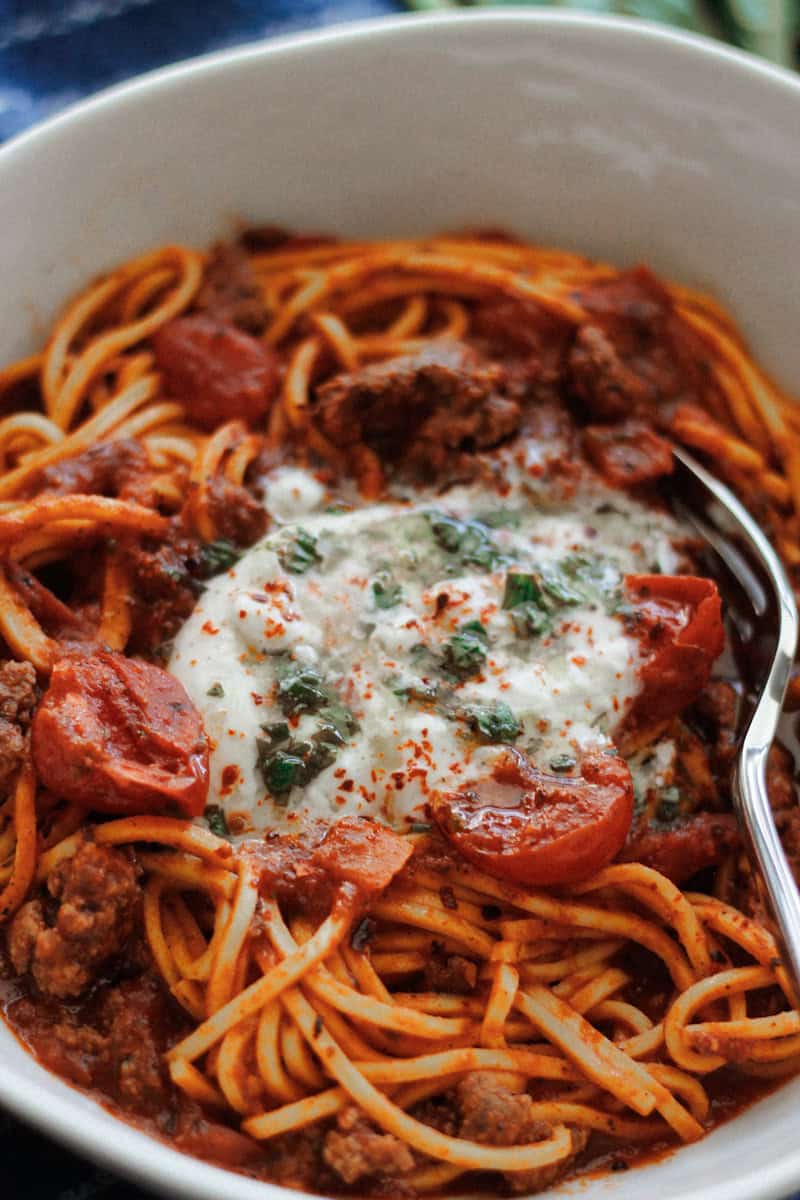 Beefy Pasta with Tomatoes and Burrata drizzled withLemon Basil Oil.