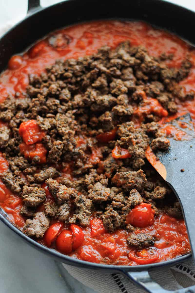 Seasoned ground beef added to jarred marinara sauce and tomatoes.