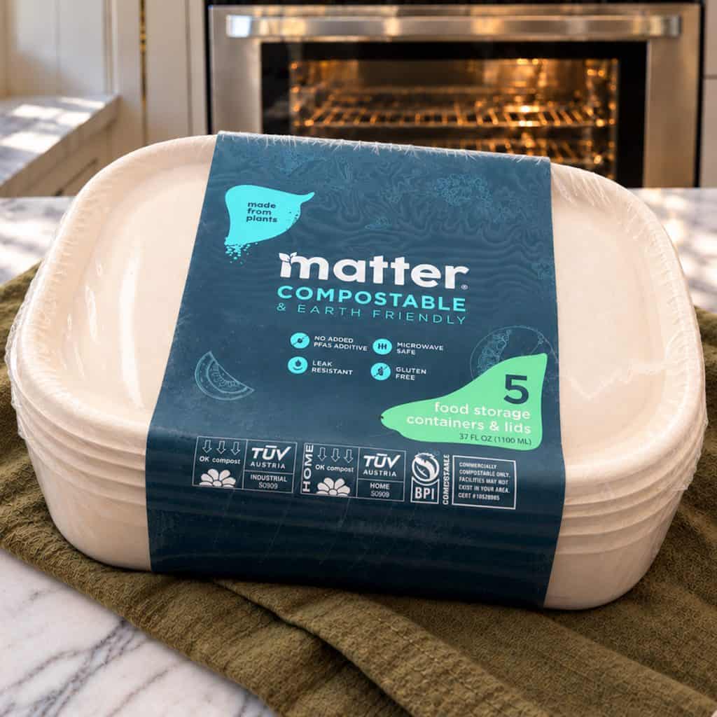 Compostable food storage containers on top of a kitchen towel on the kitchen counter.